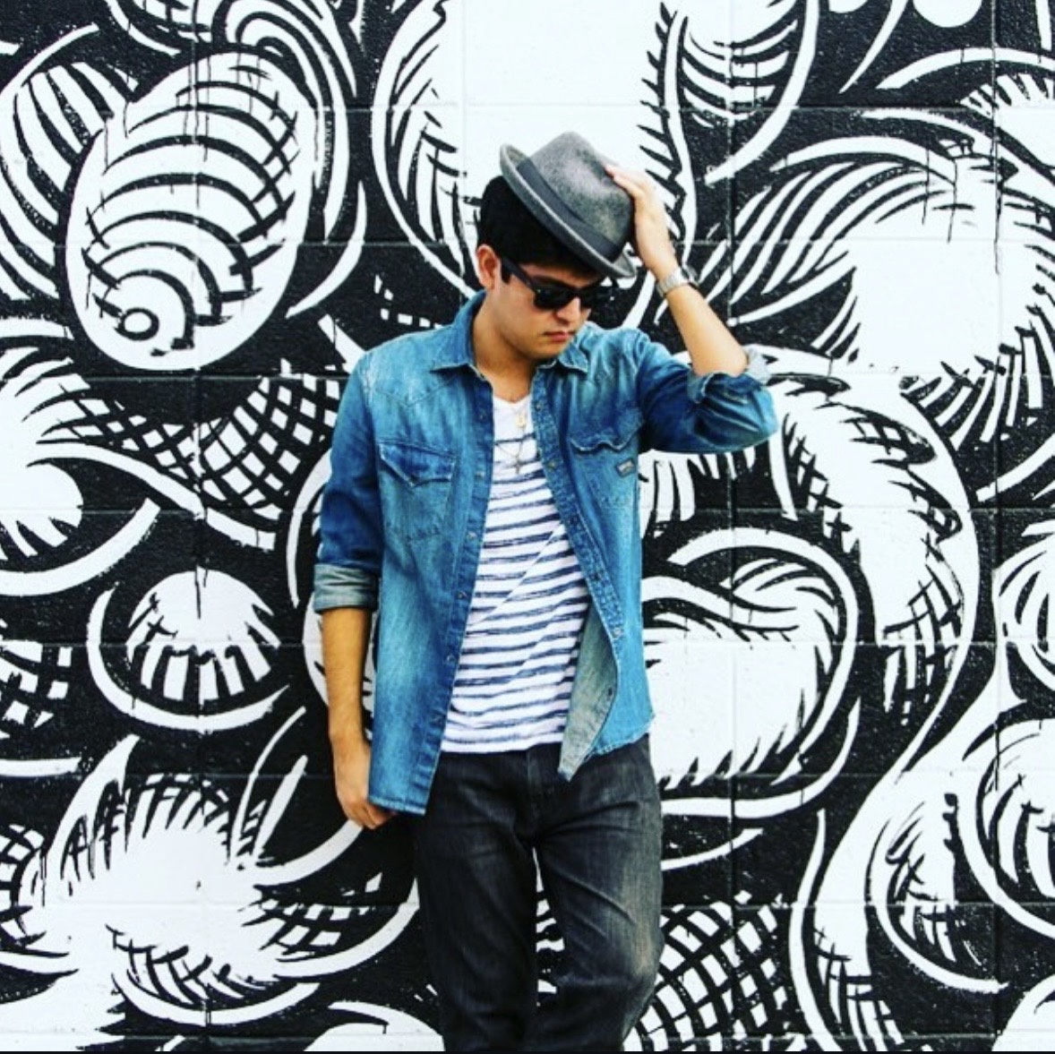 Darrin Chinen posing in front of a mural
