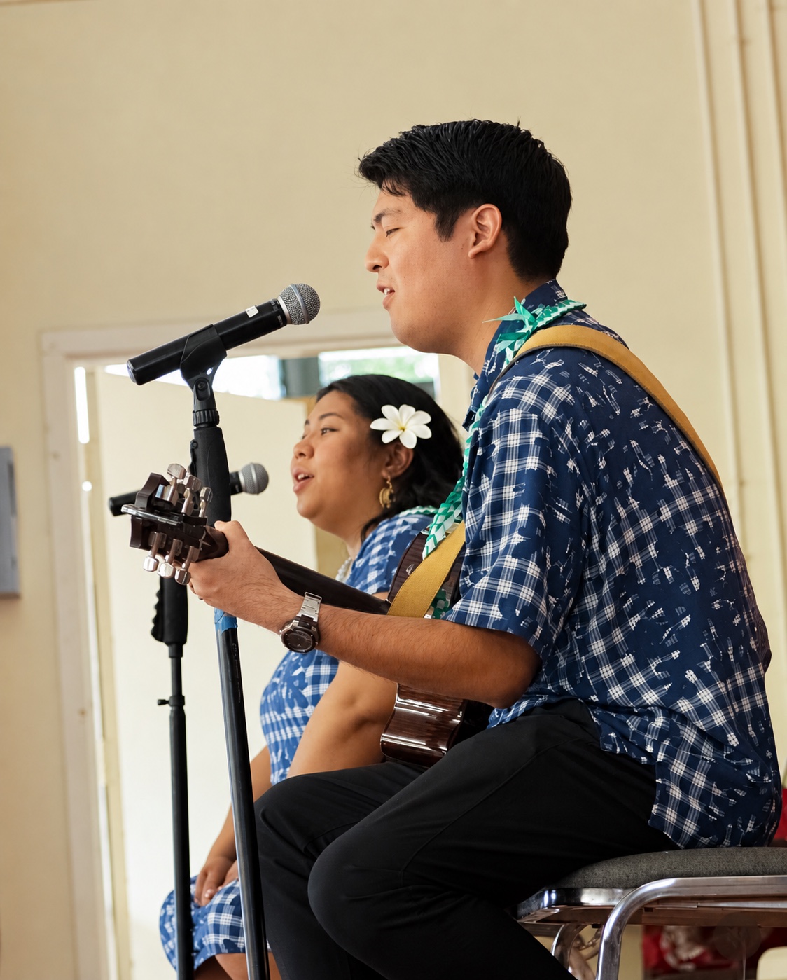Darrin Chinen singing and playing guitar with a vocalist