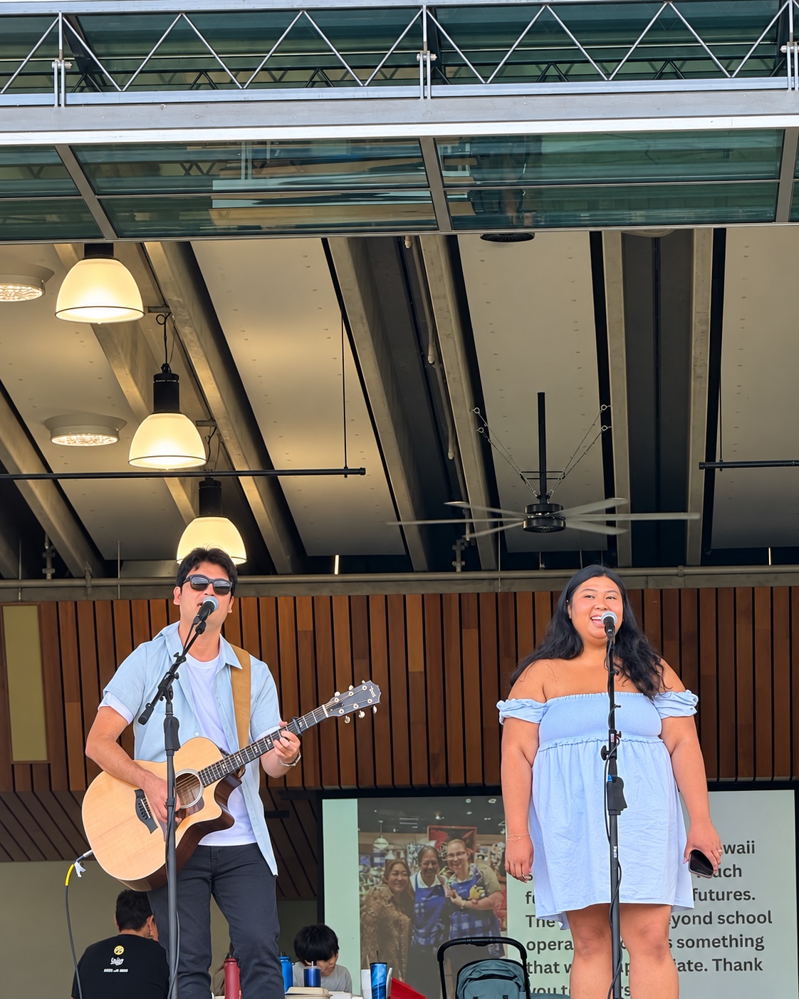 Darrin Chinen performing with a vocalist at an outdoor event